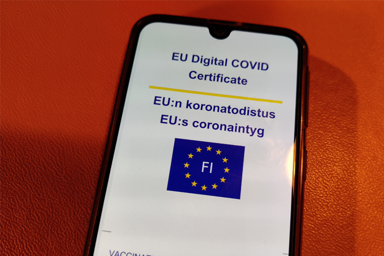 EUs logo och ett covidintyg fotograferat på en smarttelefonskärm.